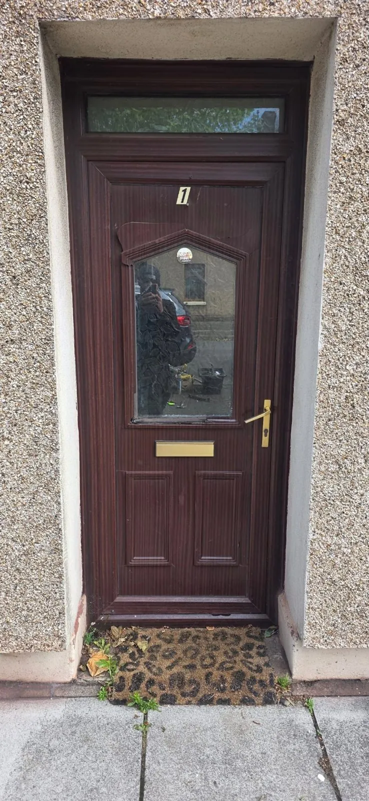 Old wood-effect front door before composite door replacement