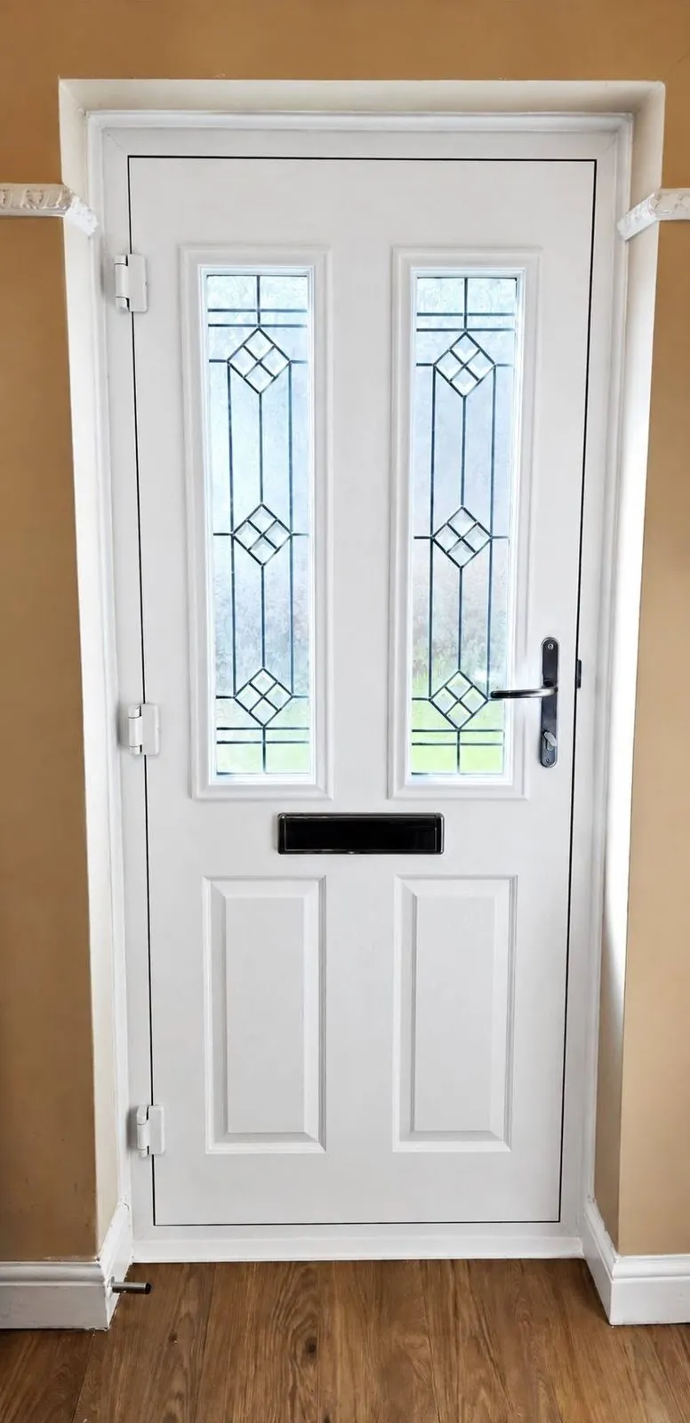 White composite front door with leaded glass panels, interior view
