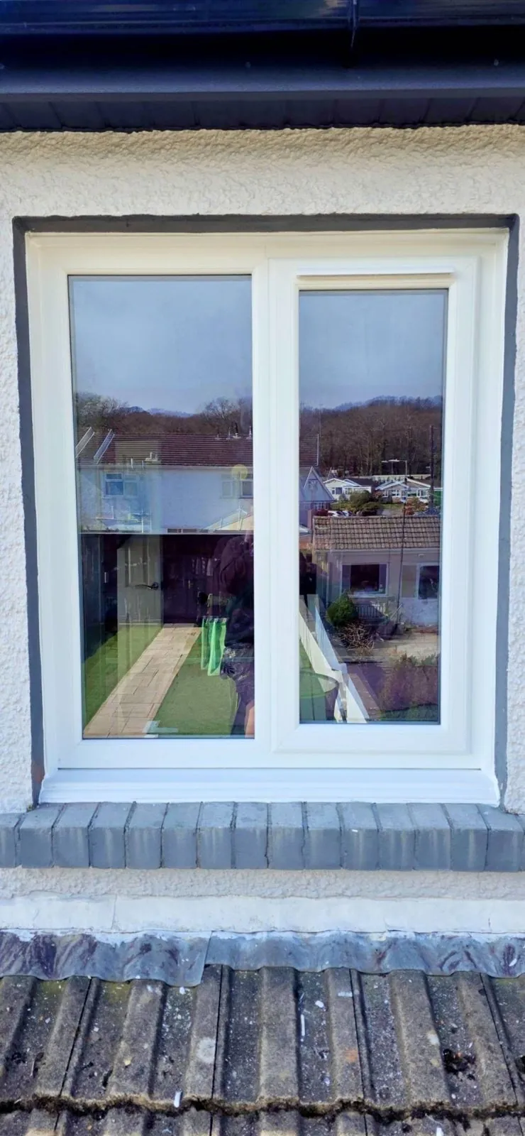 New white uPVC window in a white-rendered exterior wall