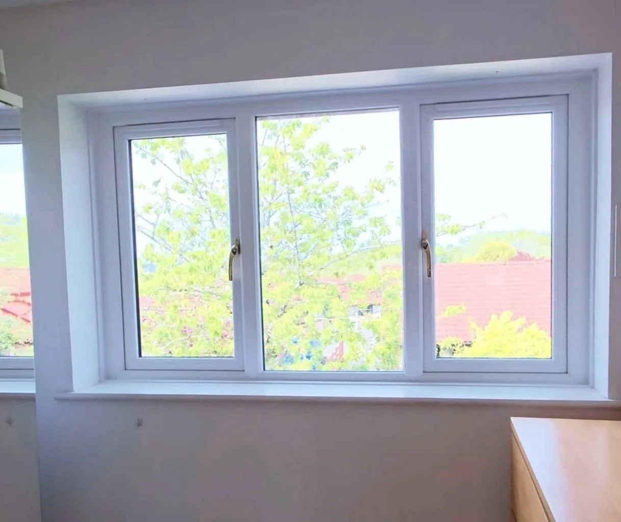 Wide white uPVC window with garden view