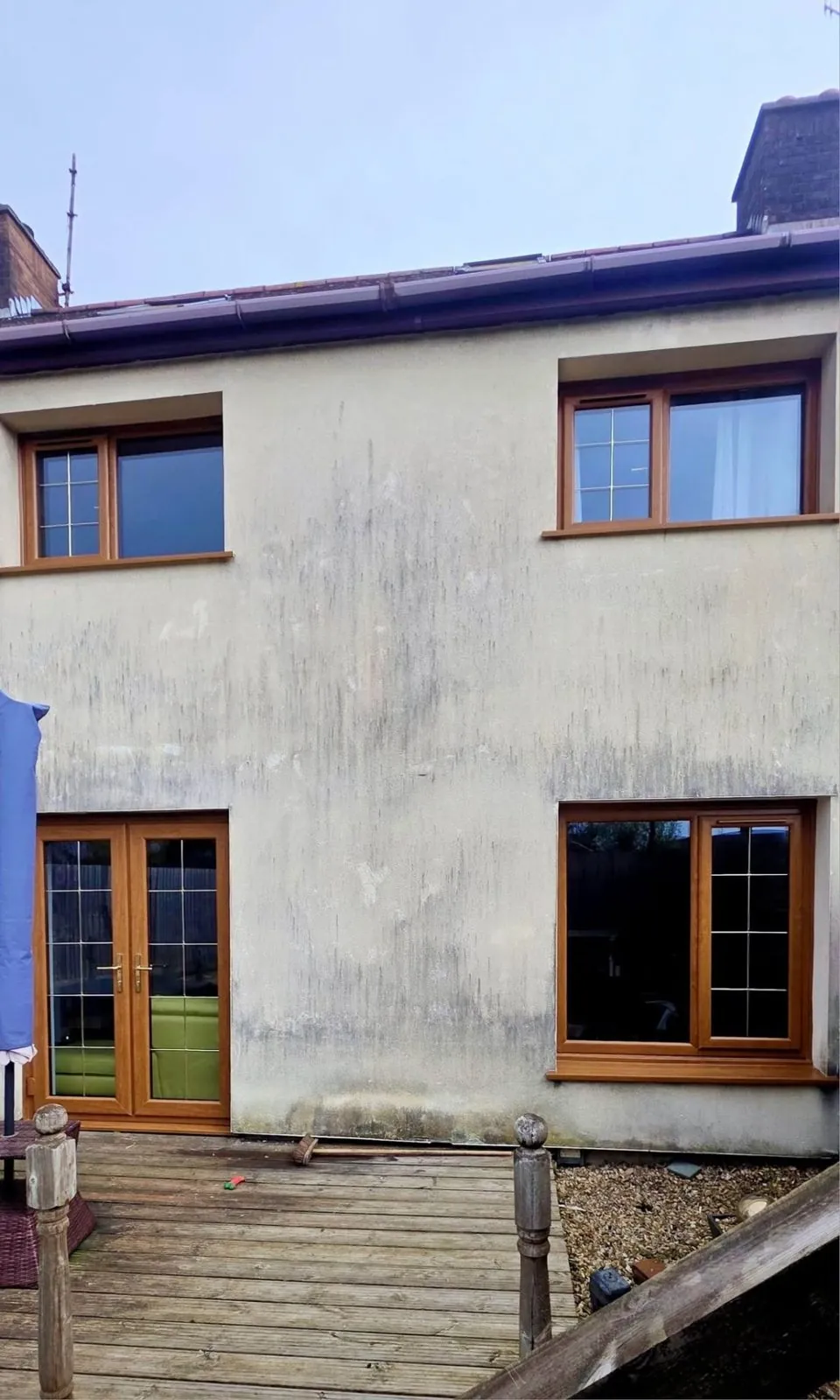 Rear of a house with oak effect double glazed windows and French doors