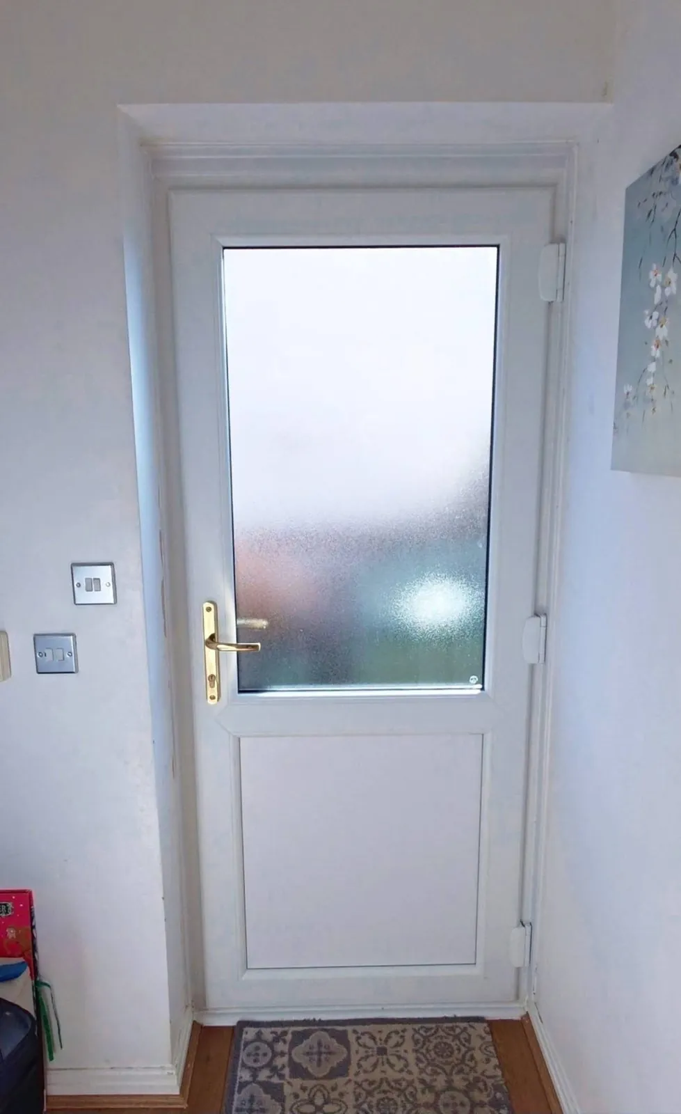 White uPVC back door with obscure glass, interior view