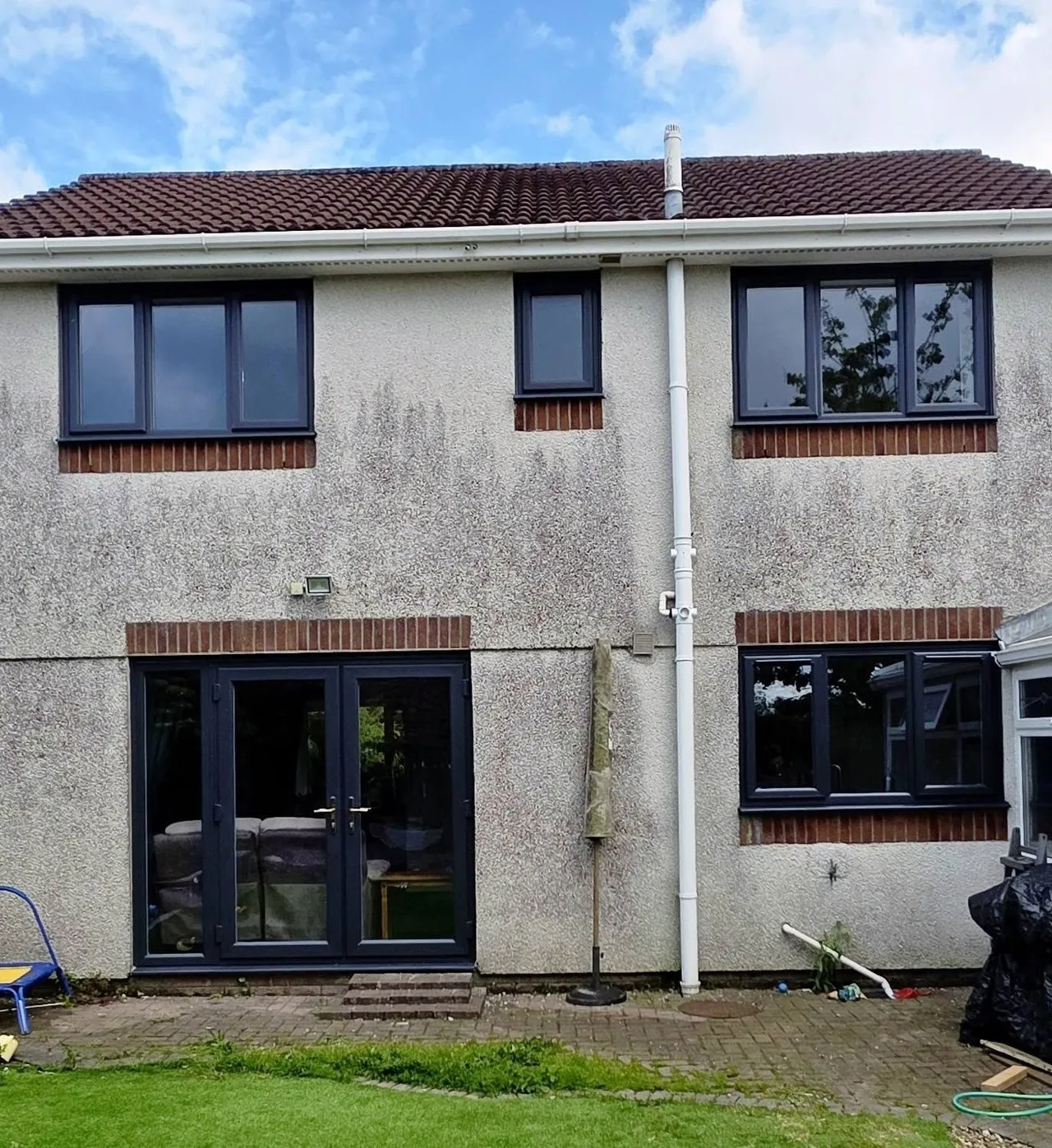 Rear of a house with new anthracite double glazed windows and French doors