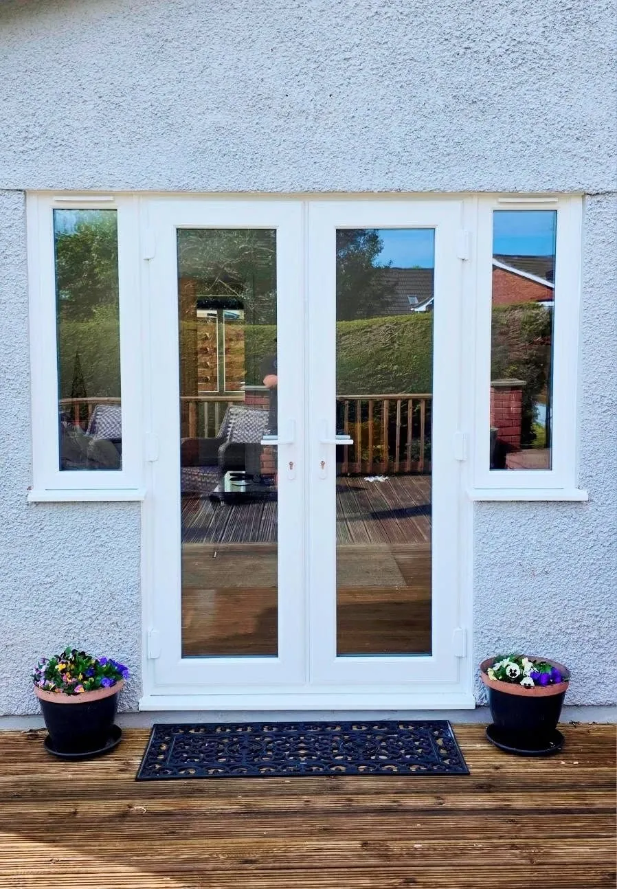 White uPVC French doors with side windows, exterior view