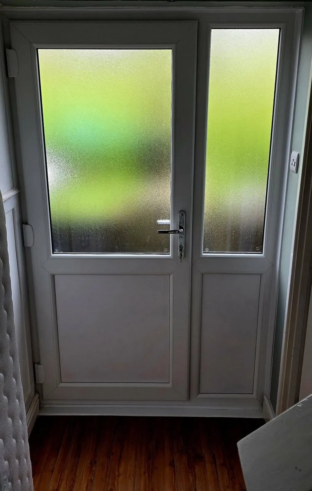 White uPVC door with obscure glazed side panel