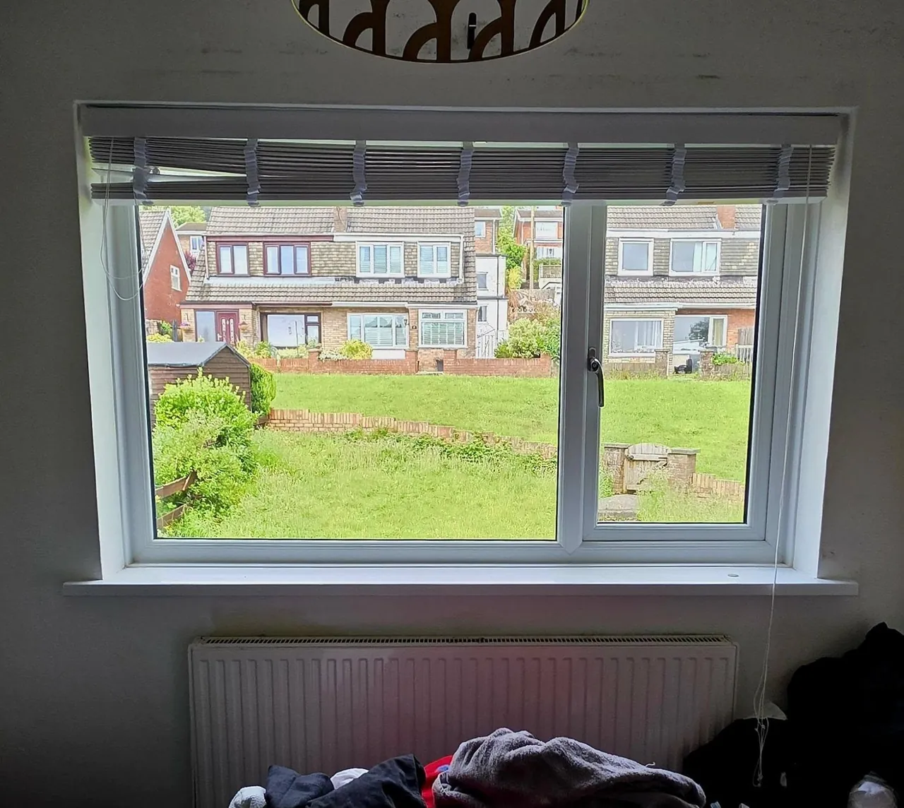 White uPVC window with roller blind, interior view